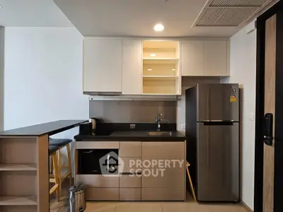Modern kitchen with sleek cabinetry, stainless steel appliances, and breakfast bar seating.
