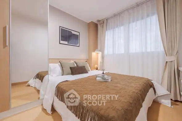 Cozy bedroom with elegant decor and large window for natural light