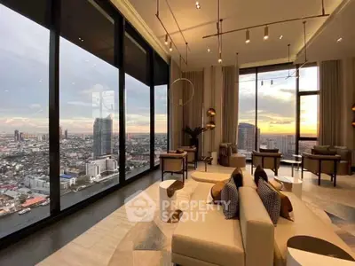 Luxurious high-rise living room with panoramic city views and modern decor.