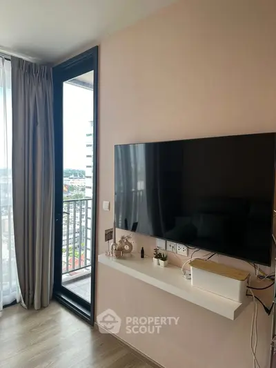 Modern living room with wall-mounted TV and balcony view