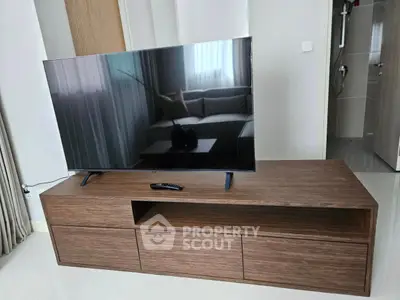 Modern living room with sleek TV stand and flat-screen television