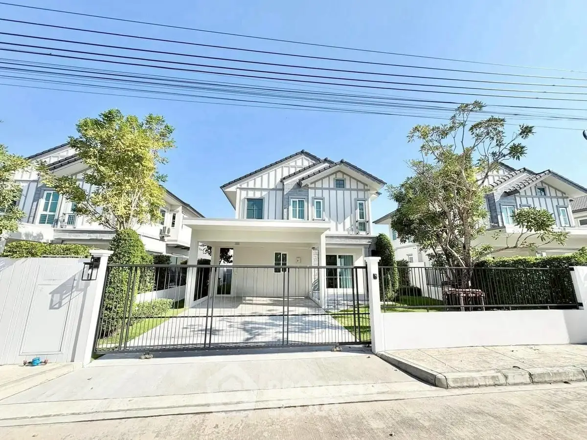 Charming modern house with spacious driveway and lush greenery in a serene neighborhood.