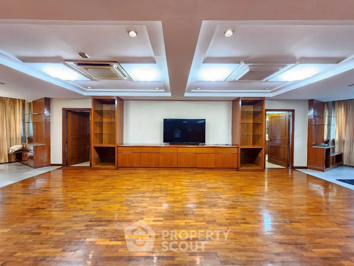 Spacious living room with wooden flooring and built-in entertainment unit