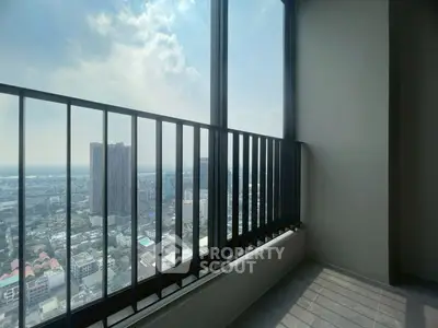 Stunning high-rise balcony with panoramic city view and ample sunlight.