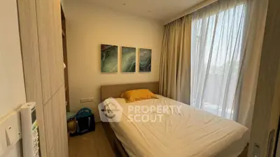 Cozy bedroom with natural light and modern decor in a stylish apartment.