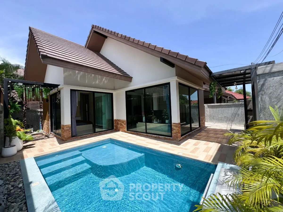 Charming modern house with private pool and spacious patio under clear blue sky.