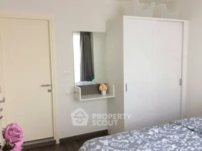 Cozy bedroom with modern white wardrobe and floral bedding