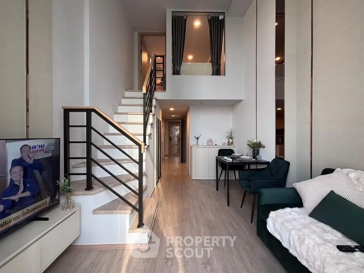 Modern duplex living room with stylish staircase and cozy seating area