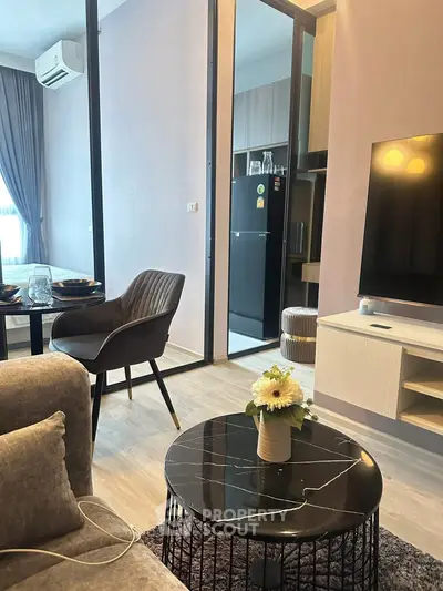 Modern living room with sleek furniture and open kitchen layout