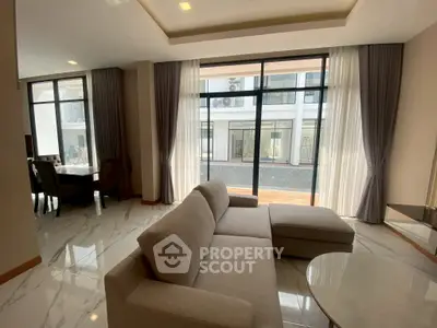 Spacious modern living room with large windows and elegant decor