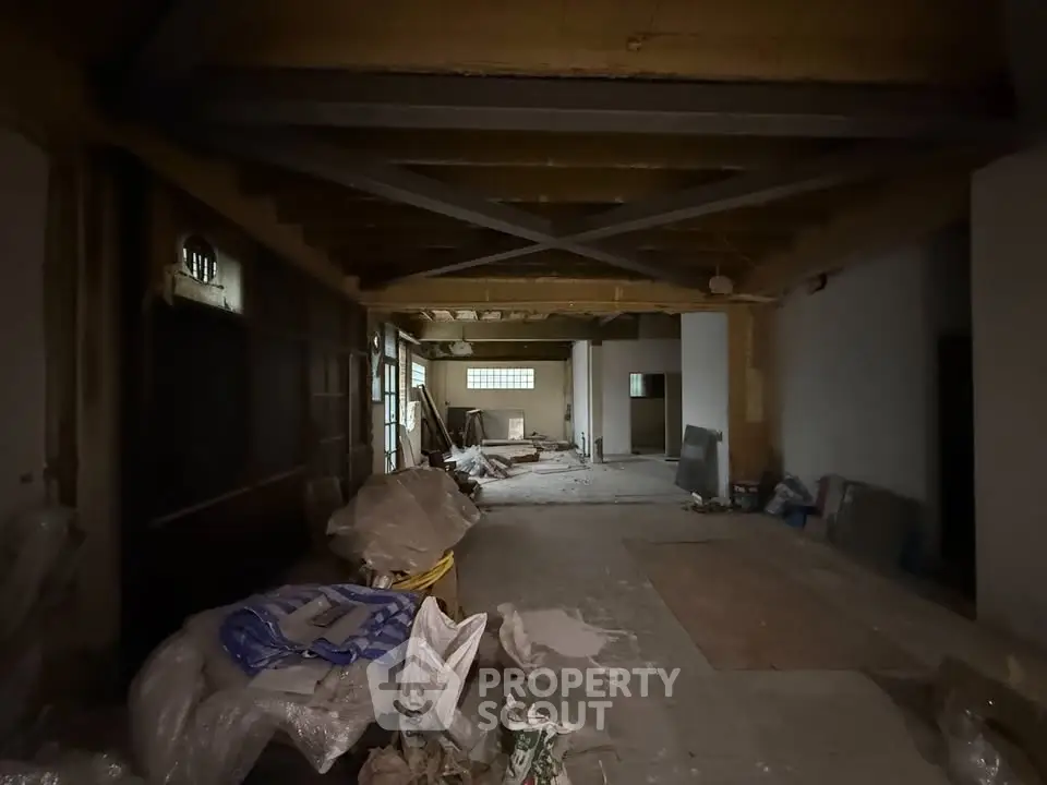 Spacious unfinished interior space with exposed beams and construction materials, ideal for customization.
