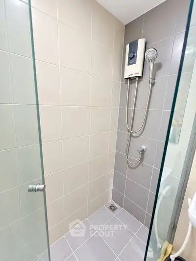 Modern bathroom with glass shower enclosure and sleek tile design