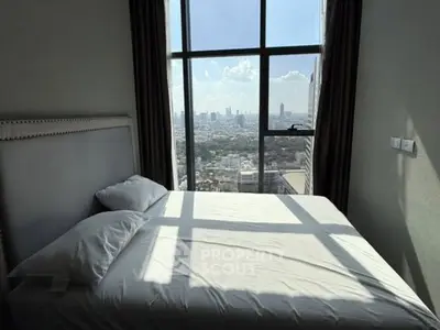 Luxurious bedroom with stunning city view from floor-to-ceiling window.