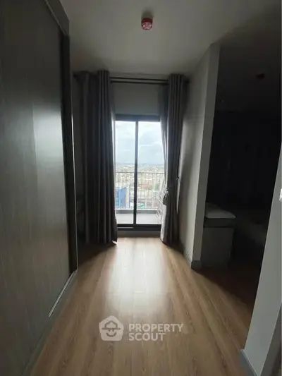 Modern apartment interior with balcony view and wooden flooring