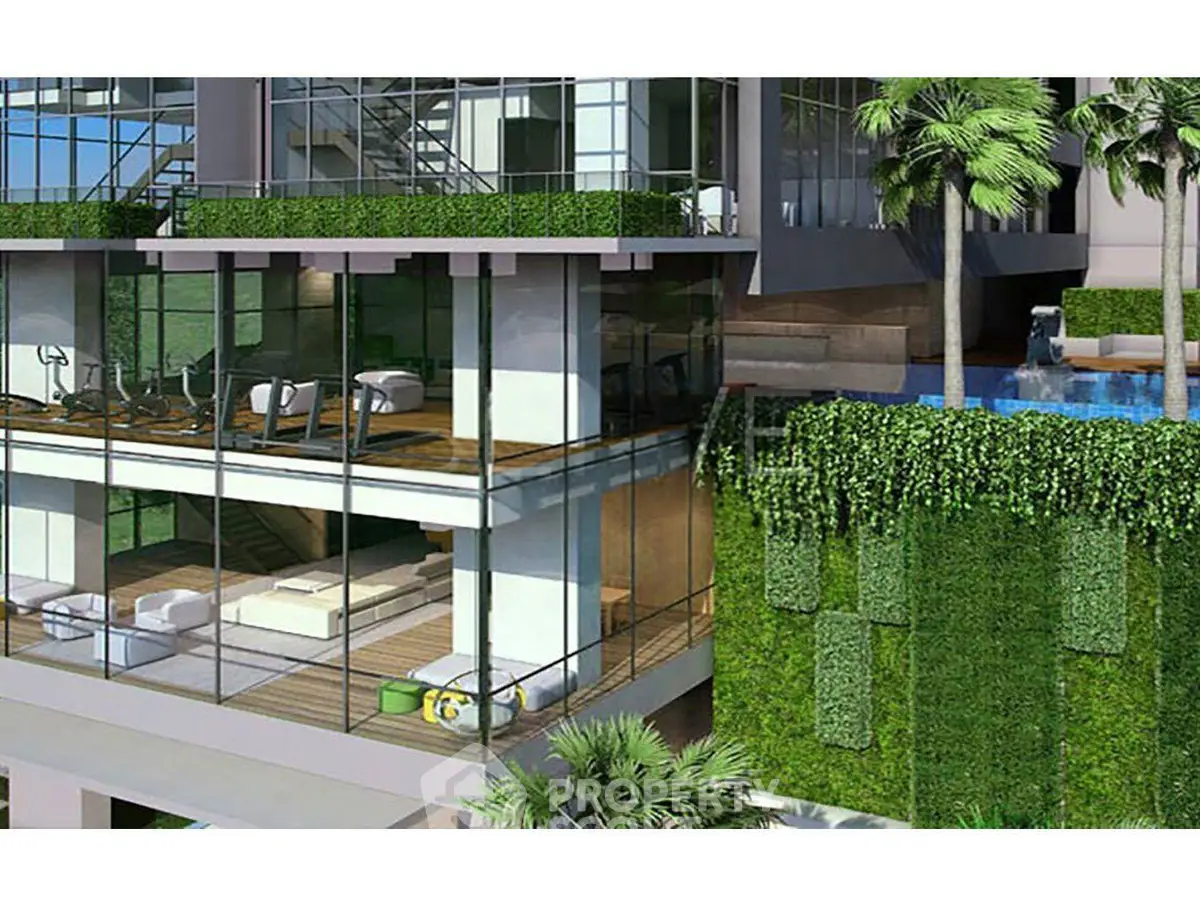 Luxurious modern building with glass facade, gym, and pool surrounded by lush greenery.