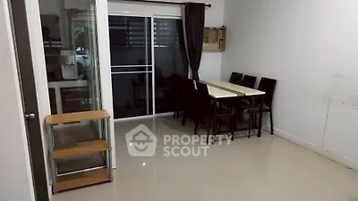 Spacious dining area with modern table and chairs, sliding glass doors leading to a balcony, perfect for entertaining.