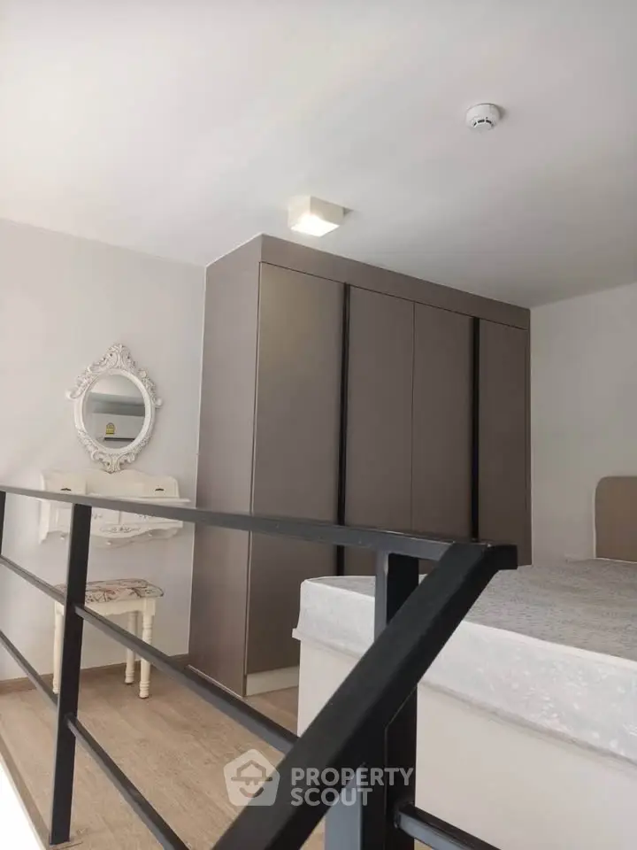 Modern bedroom with stylish wardrobe and elegant mirror, perfect for urban living.