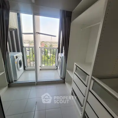 Modern laundry area with washing machine and storage overlooking scenic view