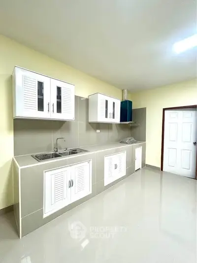 Modern kitchen with sleek cabinetry and ample counter space in a bright, minimalist design.