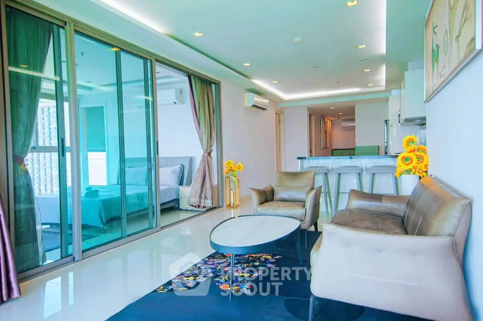 Luxurious open-plan living room with modern decor and large windows in a high-rise apartment.
