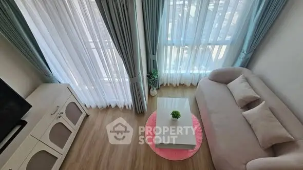 Charming living room with elegant curtains and cozy sofa, perfect for relaxation.