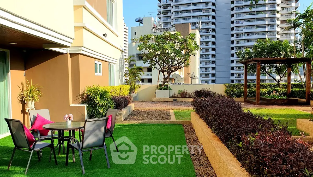 Luxurious garden terrace with seating area in modern apartment complex