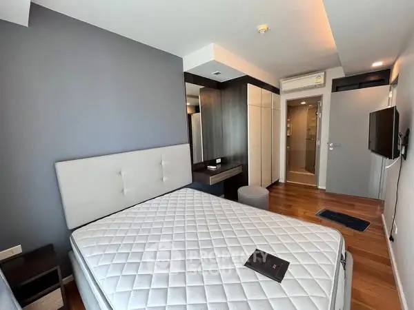 Modern bedroom with sleek design and wooden flooring