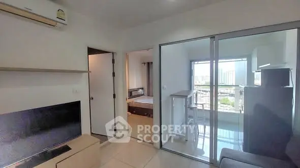 Modern apartment interior with open layout and city view, featuring a cozy living area and bedroom.