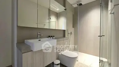 Modern bathroom with sleek fixtures and glass shower enclosure