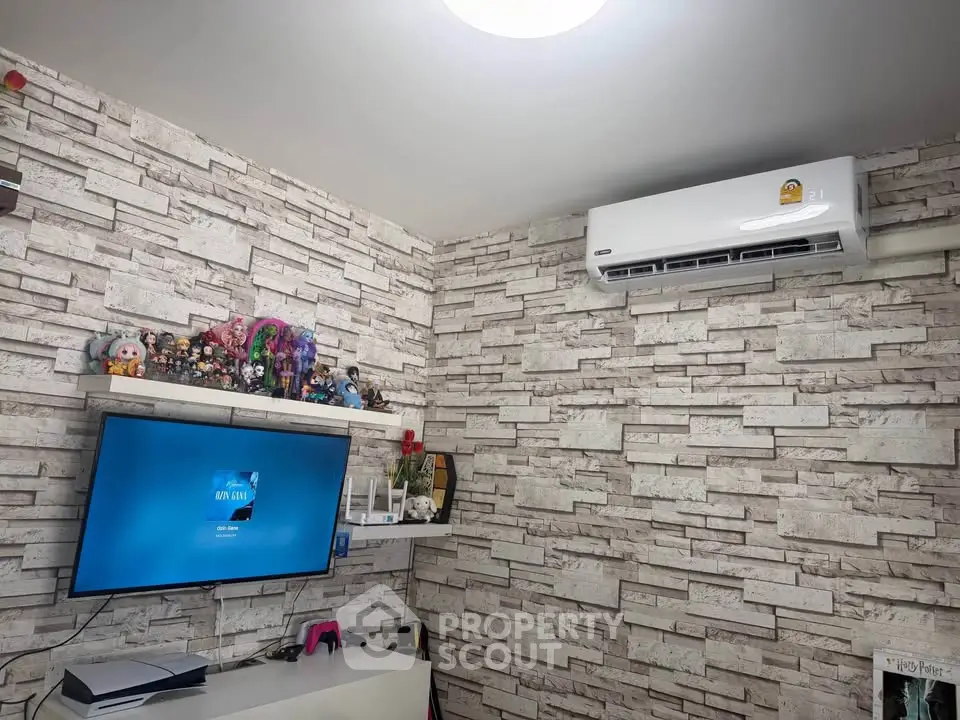 Modern living room with stylish brick wallpaper and wall-mounted TV
