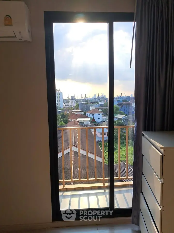 Stunning city view from a modern apartment balcony with ample natural light.