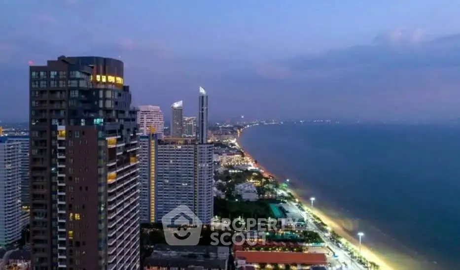 Stunning beachfront cityscape with high-rise buildings and ocean view at dusk.