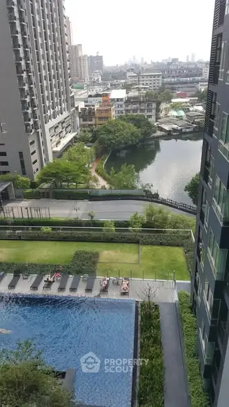 High-rise apartment view with pool and cityscape in the background