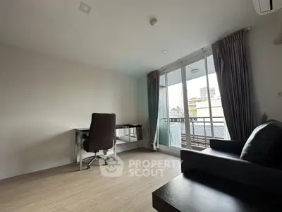 Spacious modern living room with balcony access and sleek furnishings
