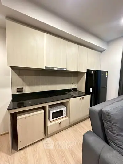 Modern kitchen with sleek cabinetry and built-in appliances in a stylish apartment.