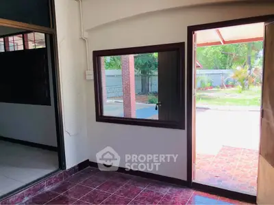 Charming entryway with tiled floor and large window overlooking garden
