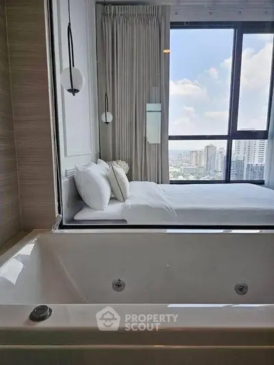 Luxurious bedroom with city view and in-room bathtub for ultimate relaxation.