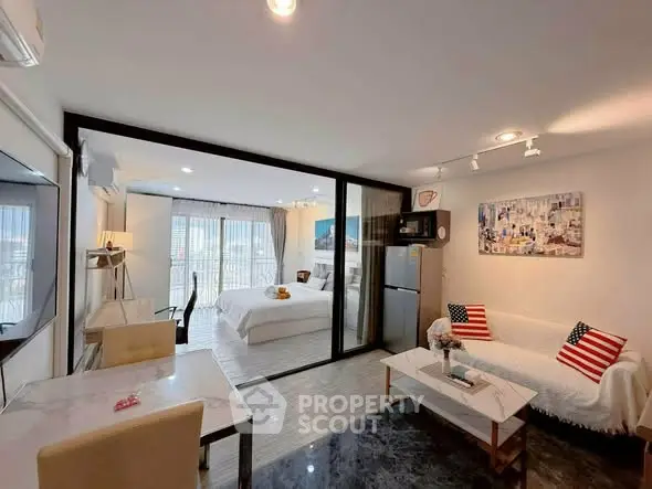 Modern studio apartment with open layout, featuring a cozy living area and stylish bedroom with city views.