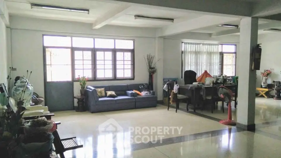 Spacious living room with ample natural light and modern furnishings