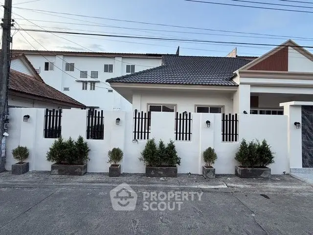 Charming suburban house with modern facade and potted plants