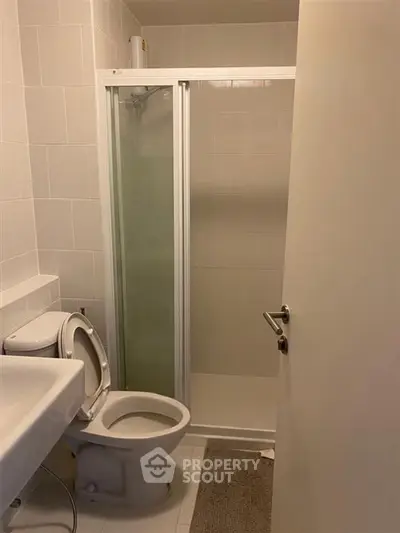 Compact bathroom with shower and toilet in modern apartment