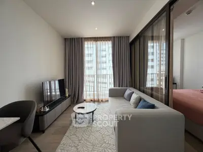 Modern living room with cozy sofa and large windows in a stylish apartment.