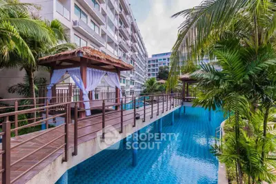 Luxurious apartment complex with stunning pool and tropical landscaping