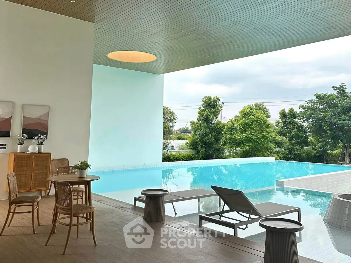 Luxurious modern poolside area with stylish seating and serene views, perfect for relaxation and entertainment.