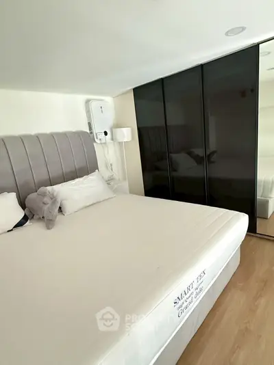 Modern bedroom with sleek wardrobe and plush bedding