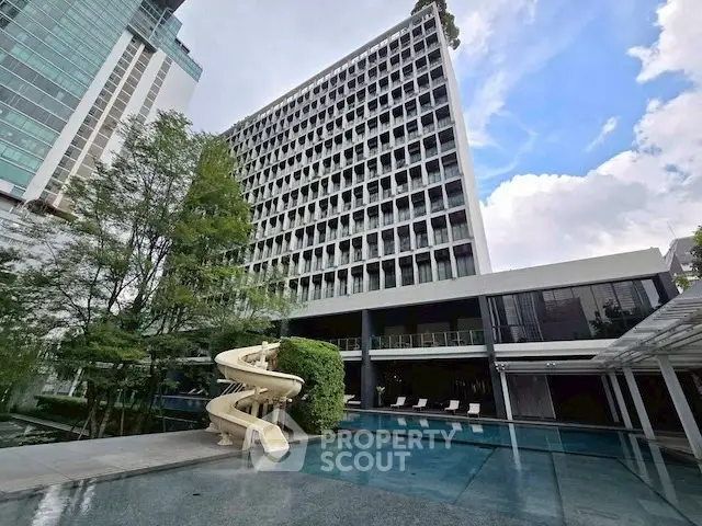 Modern building with pool and slide, perfect for luxury living.