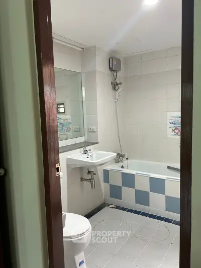 Cozy bathroom with bathtub and modern fixtures in a well-lit space.