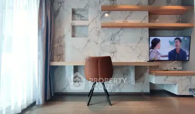 Modern living room with marble accent wall, sleek shelves, and a mounted TV, perfect for stylish urban living.