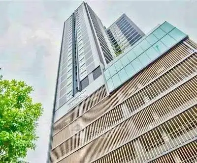 Modern high-rise building with sleek architectural design and glass facade.