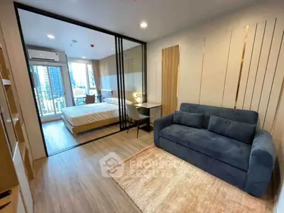 Modern studio apartment with glass partition, cozy living area, and city view balcony.